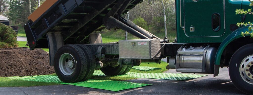 Dump truck backing over Bam ground protection mats